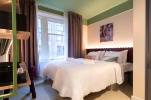 a hotel room with a bed and a window at City Hotel Rembrandt Square - Just renovated in Amsterdam