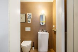 a bathroom with a white toilet and a sink at Dal Cardinale in Novara