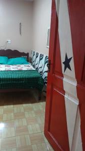 a room with a bed and an american flag at Varandas do mar II in Abade