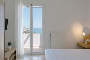 a white bedroom with a view of the ocean at Villa Aldea Bali - Sea View - Private Pool in Vlikhádha +57 photos