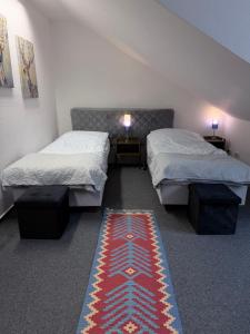 a room with two beds and a rug on the floor at Gemütliches City-Appartment in Wentorf bei Hamburg