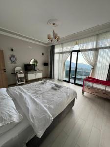 a bedroom with a large bed and a large window at Çolakoğlu konağı in Cayeli