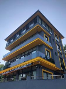 a tall building with yellow and gray at Çolakoğlu konağı in Cayeli +12 photos