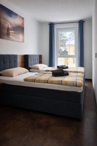 a large bed in a room with a window at ApartDays Sarstedt in Sarstedt