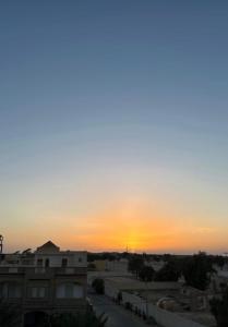 a sunset from the roof of a building at Golden Dunes in Tozeur