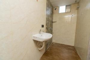 a bathroom with a sink and a shower at Aikya Service Apartment in Hyderabad