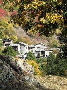 a group of houses on the side of a hill at La Caserma -The Barracks in Bobbio Pellice