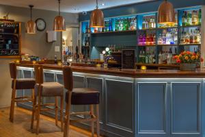 a bar in a pub with two stools at Kings Court Hotel Alcester, BW Signature Collection in Stratford-upon-Avon