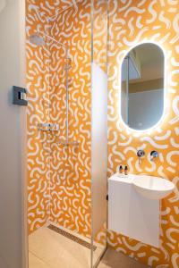 a bathroom with a shower and a sink and a mirror at City Hotel Rembrandt Square - Just renovated in Amsterdam +85 photos