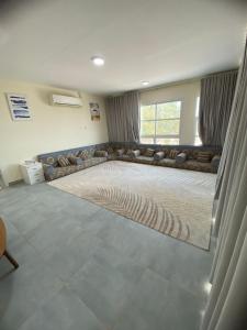 a living room with a couch and a large rug at السلع in Sabkhah