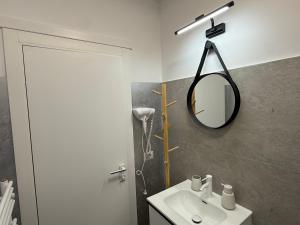 a bathroom with a sink and a mirror on the wall at visitor's house 2 in Rădăuţi
