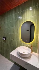 a bathroom with a sink and a mirror at Chài Beach Homestay in Ninh Hải