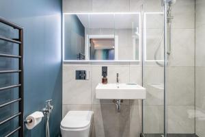 a bathroom with a sink and a toilet and a mirror at Stylish Flat next2 Wimbledon with a parking in Mitcham Junction +16 photos