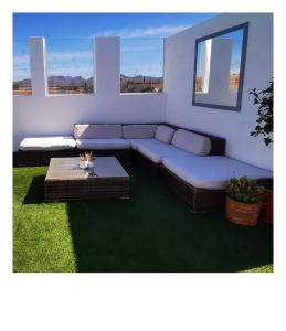 a living room with a couch and a table at Villa Gozo Holiday house in Teguitar