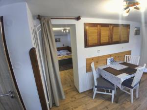 a kitchen and dining room with a table and chairs at Apartmán Astomo in Vrchlabí +10 photos