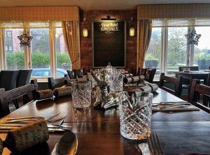 a dining room with a table with glasses on it at The Steam Packet Inn in Totnes