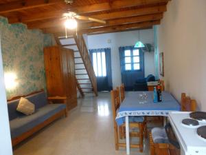 a living room with a table and a dining room at Athina Apartments in Arillas