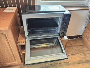 a stove in a kitchen with its door open at Apartmán Astomo in Vrchlabí