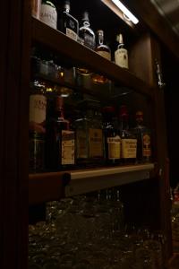 a shelf with many bottles of alcohol on it at The Steam Packet Inn in Totnes +49 photos