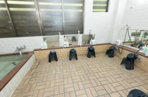 a bathroom with a bunch of equipment on a tiled floor at 苗場ロッヂ丘 in Yuzawa