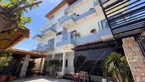 an apartment building with balconies and palm trees at Chài Beach Homestay in Ninh Hải +2 photos