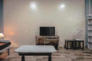 a living room with a tv and a coffee table at The Southside Den in Āīzawl