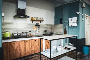 a kitchen with blue and white walls and a counter at The Southside Den in Āīzawl