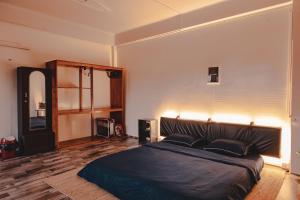 a bedroom with a large bed with two pillows at The Southside Den in Āīzawl