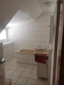 a bathroom with a tub and a sink at Hotel Gasthaus Bodetal in Rübeland +8 photos