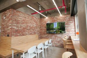 a dining room with a brick wall and a table and chairs at Stay PLAN B in Seoul