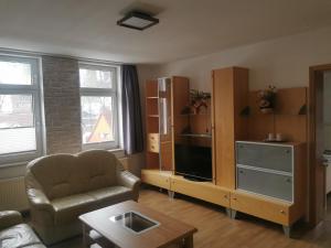 a living room with a couch and a table at Hotel Gasthaus Bodetal in Rübeland