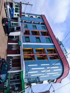 a tall blue building with lots of windows at Double twins Hotel & Suites in Yaoundé