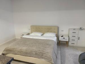 a bedroom with a large bed and a dresser at visitor's house 3 in Rădăuţi