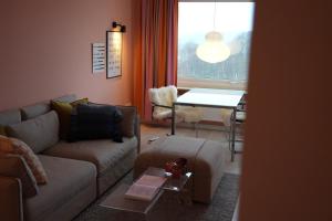 a living room with a couch and a table at Design Apartment Plön in Plön