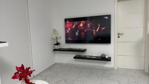 a living room with a flat screen tv on a wall at Apartment Aria in Kobarid