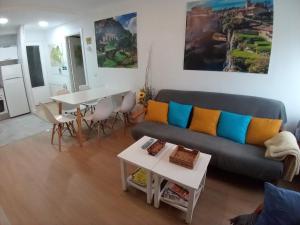 a living room with a couch and a table at MERINDADES AMAZUL CORZO - Apartamento Turístico - Medina de Pomar in Medina de Pomar