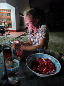 a man sitting at a table with a bowl of food at Villa iSoNet in Weligama