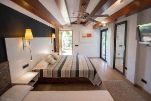 a bedroom with a bed and a ceiling fan at Catalunya Casas An oasis for up to 26 nature loving guests! in Sils +53 photos