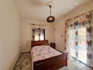 a bedroom with a bed and a window at family MARIA in Kalymnos