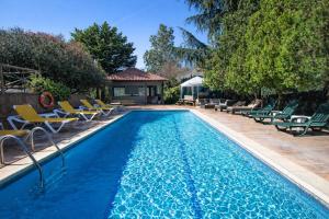 a swimming pool with chairs and a house at Catalunya Casas An oasis for up to 26 nature loving guests! in Sils