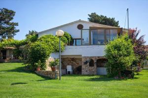 a house with a stone fireplace in a yard at Catalunya Casas An oasis for up to 26 nature loving guests! in Sils