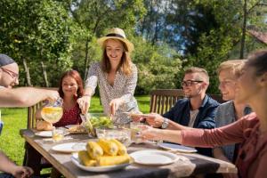 a group of people sitting around a table eating food at Catalunya Casas An oasis for up to 26 nature loving guests! in Sils