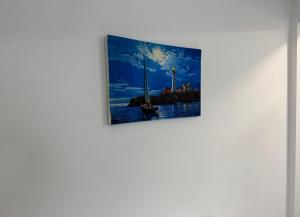 a painting hanging on a wall at visitor's house 4 in Rădăuţi +2 photos