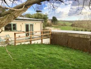 a house with a wooden fence and a yard at Mill Lane Holiday Cottage -Bath in Bath