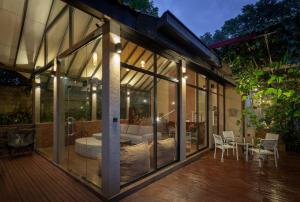a glass house with a bed and a table on a deck at Harmony Hills Boutique Villa in Ella +11 photos