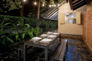 a wooden table with wine glasses on a patio at Harmony Hills Boutique Villa in Ella