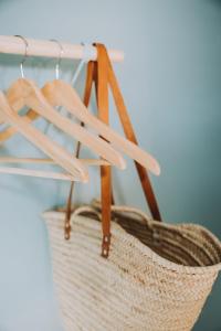 a wicker basket hanging from a wooden rack at Vakantiewoning Conterdijk 13 in Koksijde
