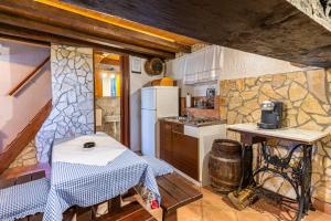 a kitchen with a refrigerator and a table in a room at Antique House Orlec in Orlec +12 photos