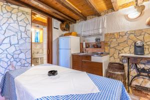 a kitchen with a table and a refrigerator at Antique House Orlec in Orlec
