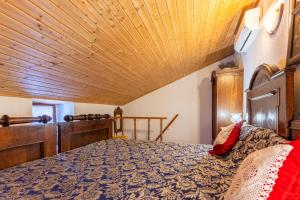 a bedroom with a bed with a wooden ceiling at Antique House Orlec in Orlec